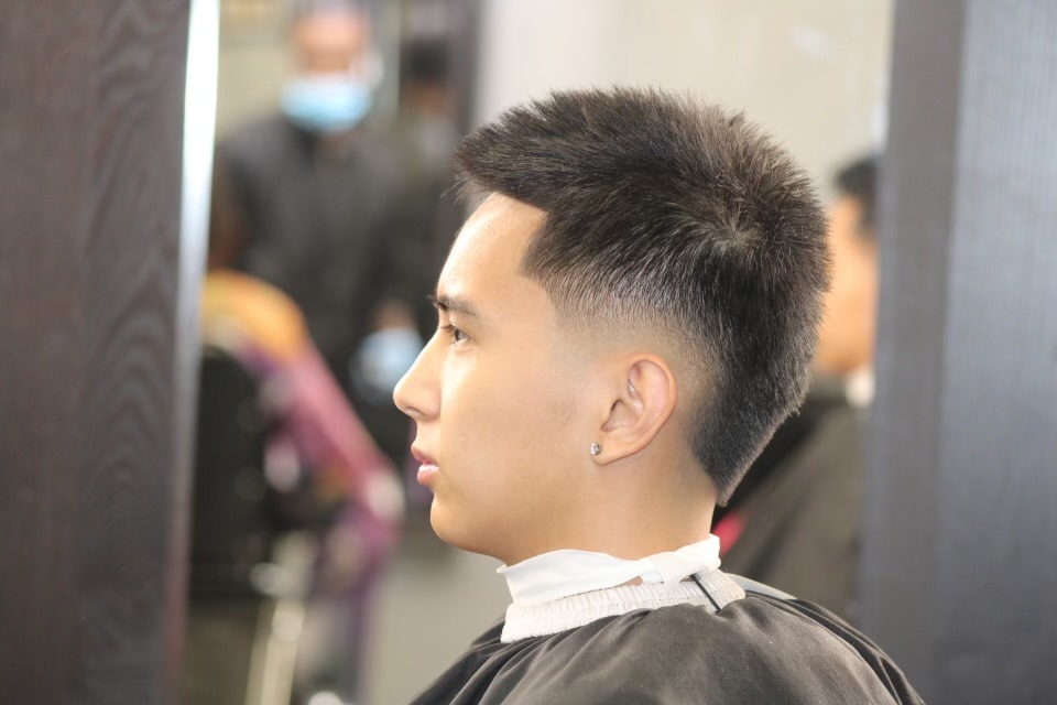 A man showcasing a striking haircut.